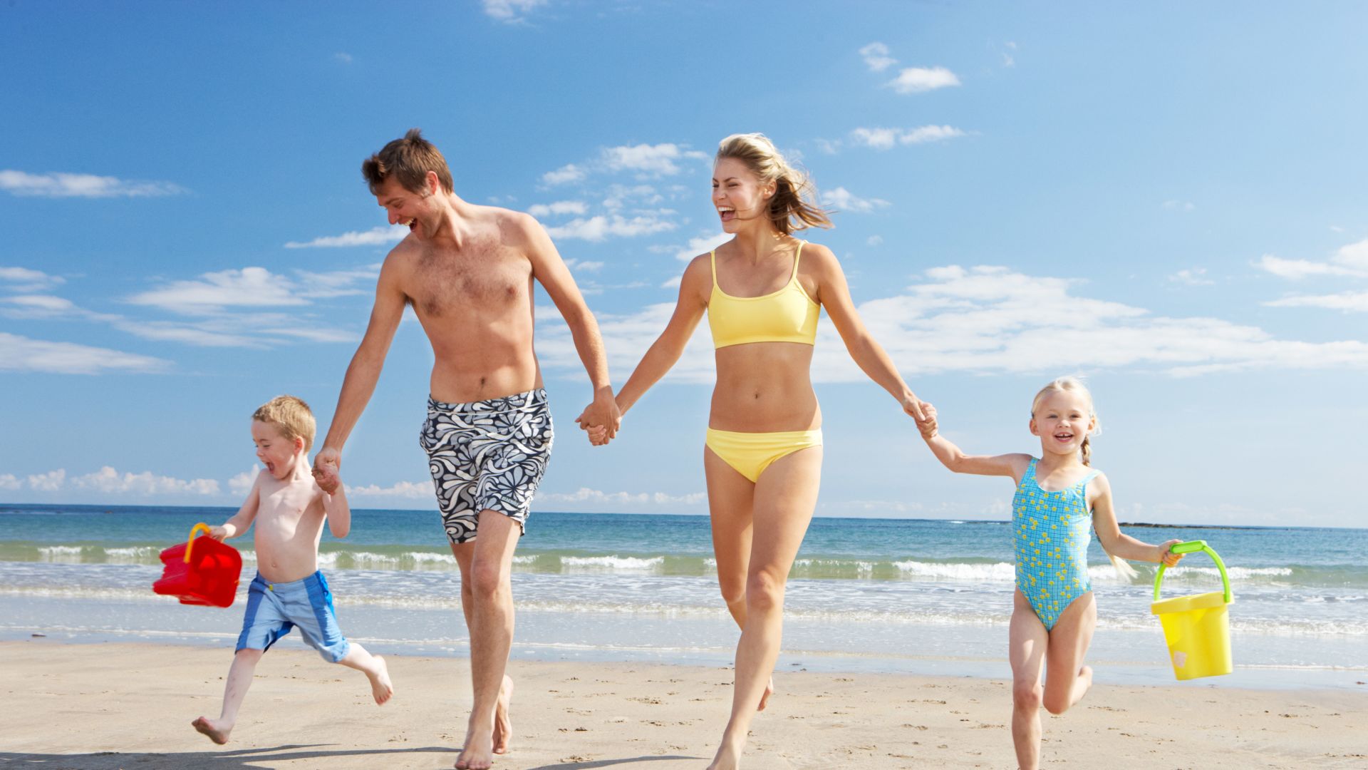 A Family Running On The Beach