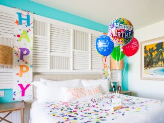 A Bedroom With A Bed And Balloons