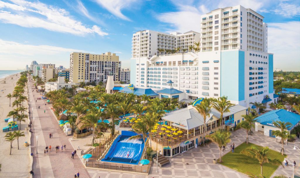 A Beach With A City In The Background