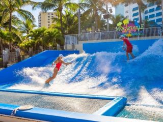 A Couple Of People Playing In A Water Park
