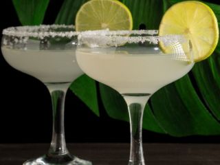 A Group Of Martini Glasses With Lemons And Limes