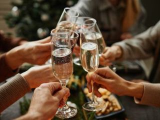 A Group Of People Holding Wine Glasses