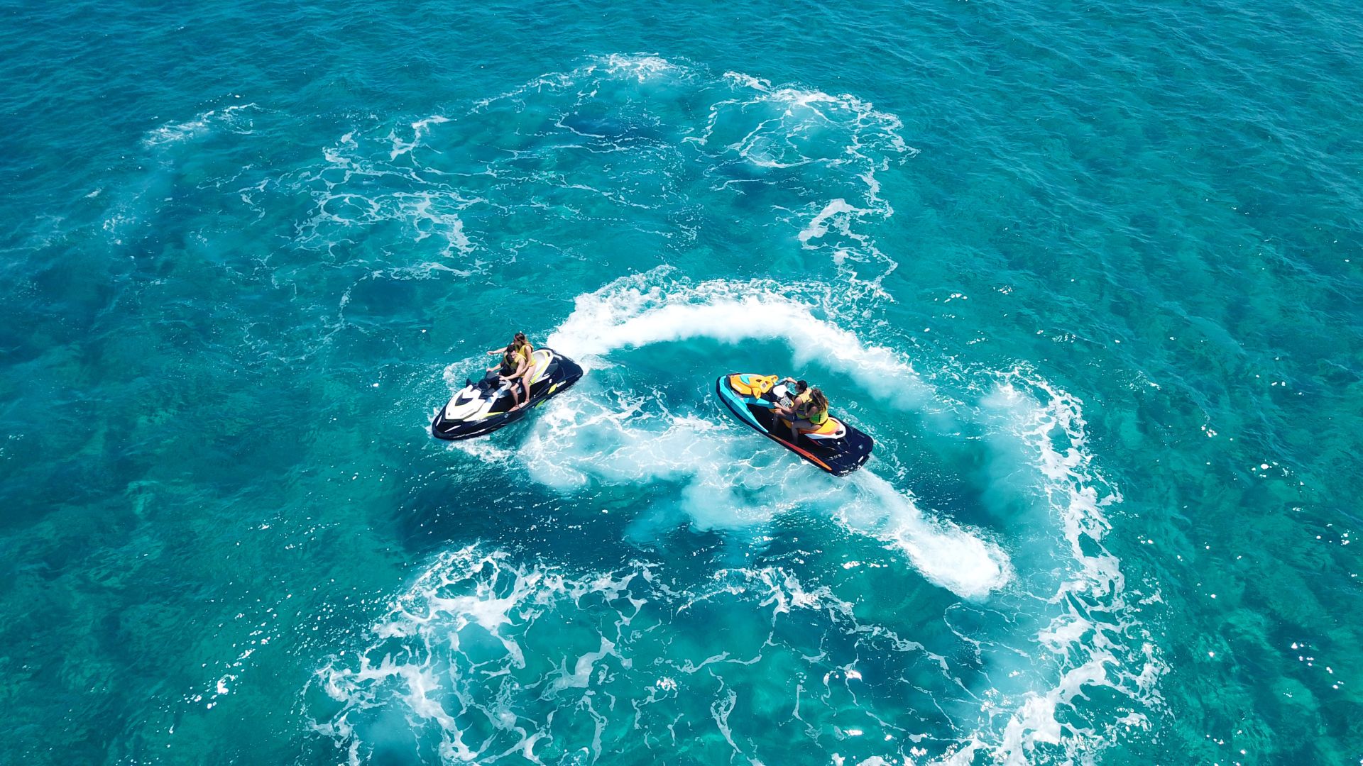 A Couple Of Boats Ride Through The Water